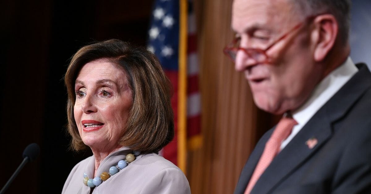 House Speaker Nancy Pelosi talks during a news conference with Senate Minority Leader Chuck Schumer at the Capitol on Feb. 11, 2020.