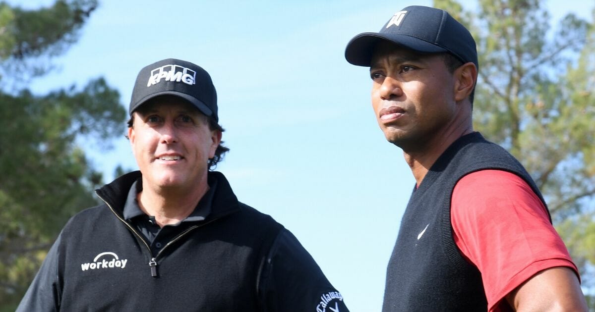 Phil Mickelson, left, and Tiger Woods look on prior to The Match: Tiger vs. Phil at Shadow Creek Golf Course in Las Vegas on Nov. 23, 2018.