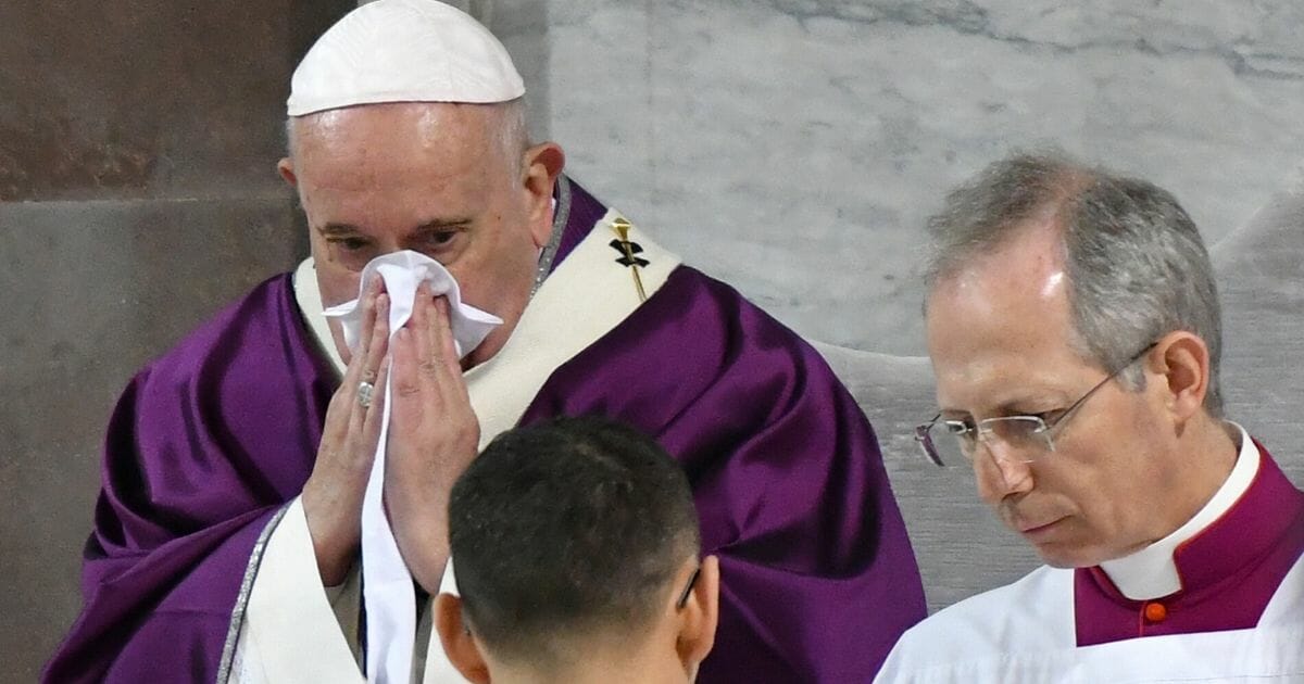 Pope Francis blows his nose as he leads the Ash Wednesday mass which opens Lent, the forty-day period of abstinence and deprivation for Christians before Holy Week and Easter, on Feb. 26, 2020, at the Santa Sabina church in Rome.
