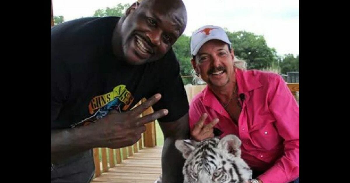 NBA legend Shaquille O'Neal poses for a photo with big cat owner Joe Exotic.