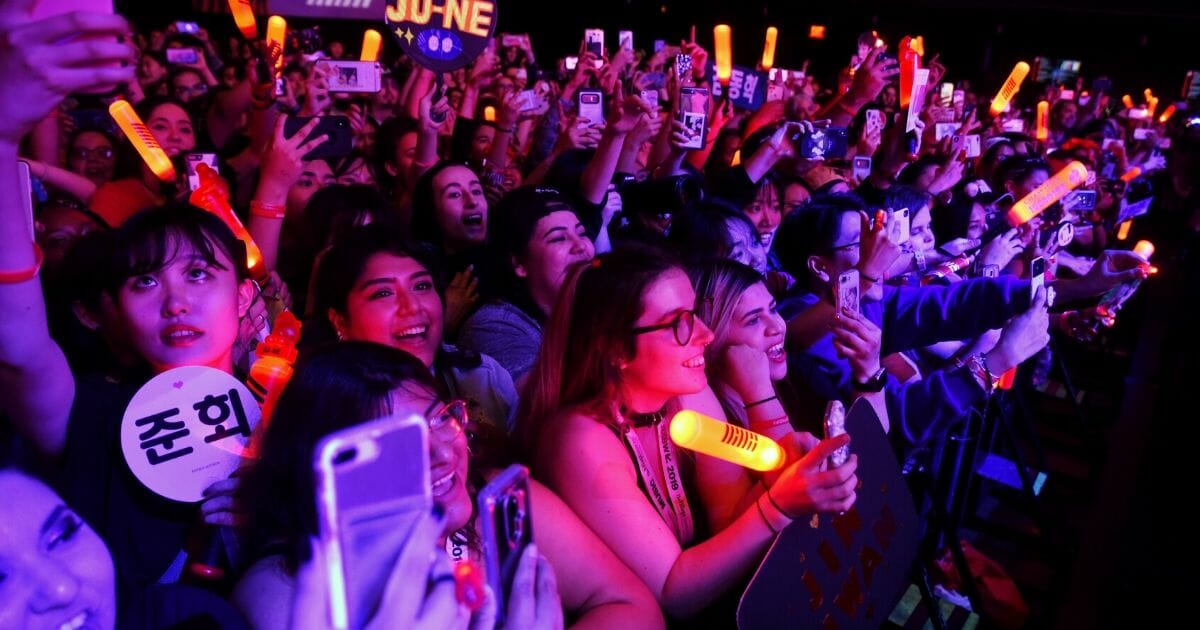 Festival-goers watch iKON perform onstage at KOCCA during the 2019 SXSW Conference and Festivals at Moody Theater on March 13, 2019. in Austin, Texas.