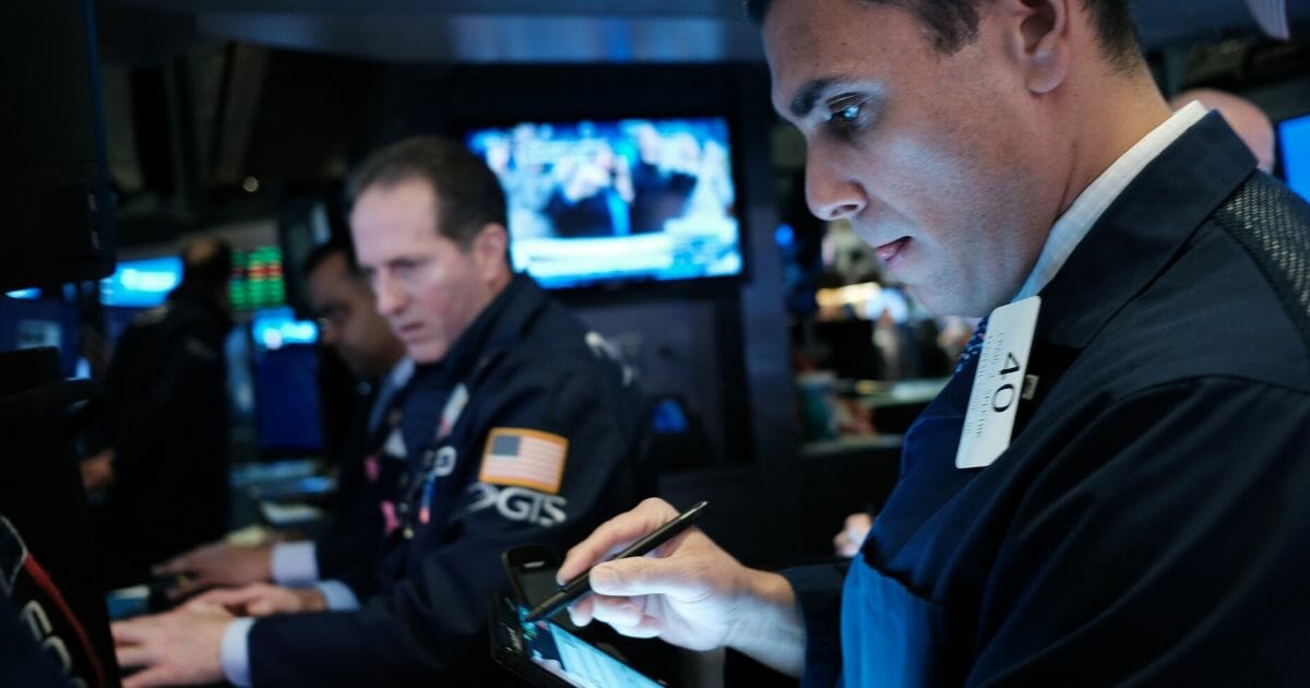 Traders work on the floor of the New York Stock Exchange on March 2, 2020.