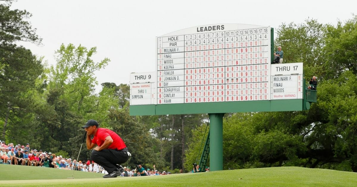 Tiger Woods of the United States lines up a putt on the 18th green during the final round of the Masters at Augusta National Golf Club on April 14, 2019, in Augusta, Georgia.