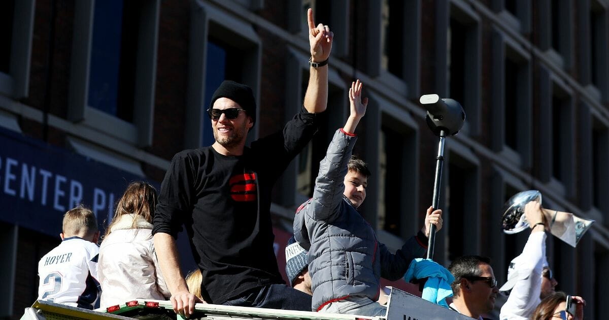 Tom Brady and his son Jack celebrate on Cambridge Street in Boston on Feb. 5, 2019, during the New England Patriots' victory parade after winning Super Bowl LIII.