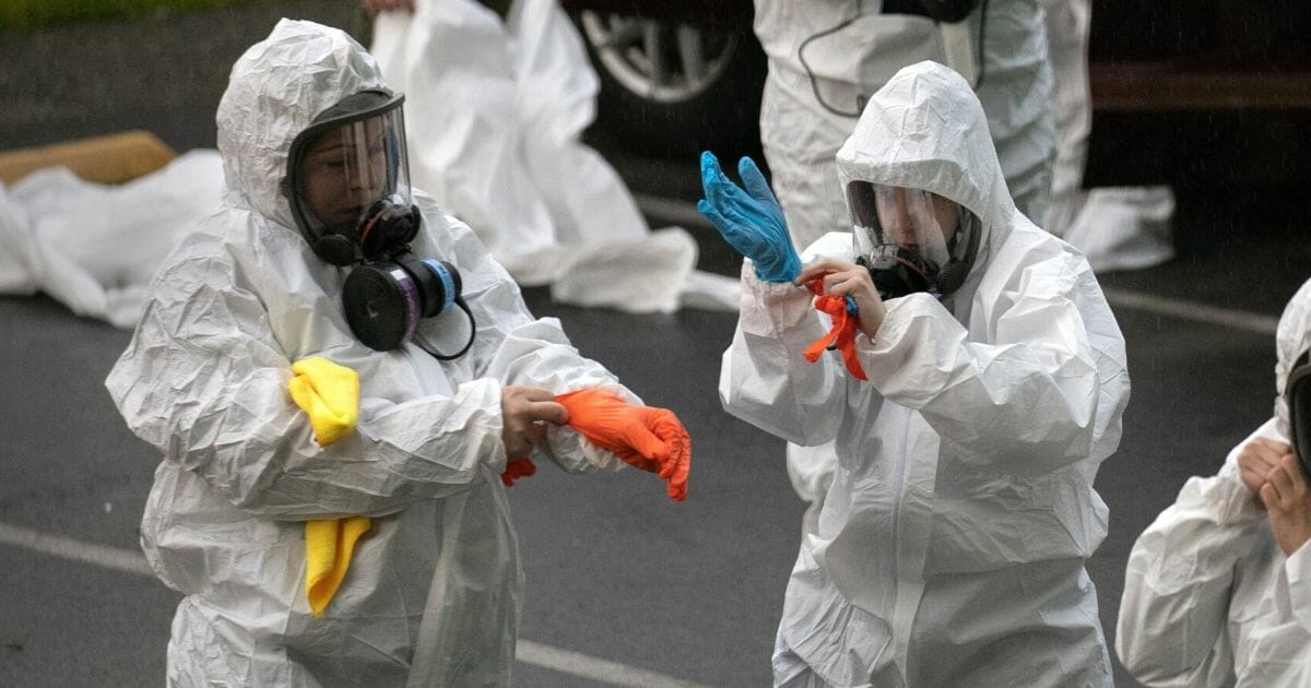 A cleaning crew suits up in protective clothing before entering the Life Care Center on March 12, 2020, in Kirkland, Washington.