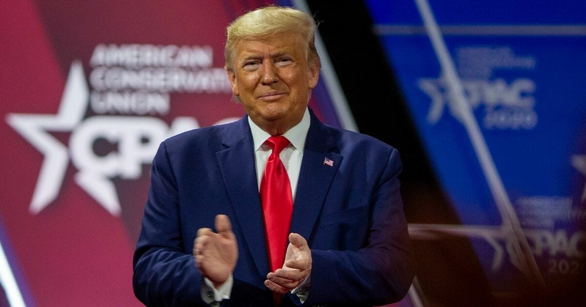 President Donald Trump joins the crowd in applause Saturday during his appearance at the Conservative Political Action Conference in National Harbor, Maryland.