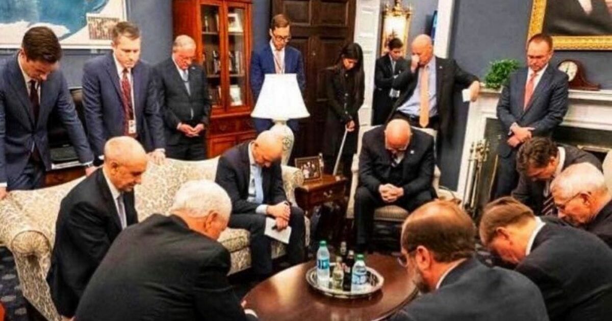 Vice President Mike Pence's coronavirus task force team prays during a meeting.