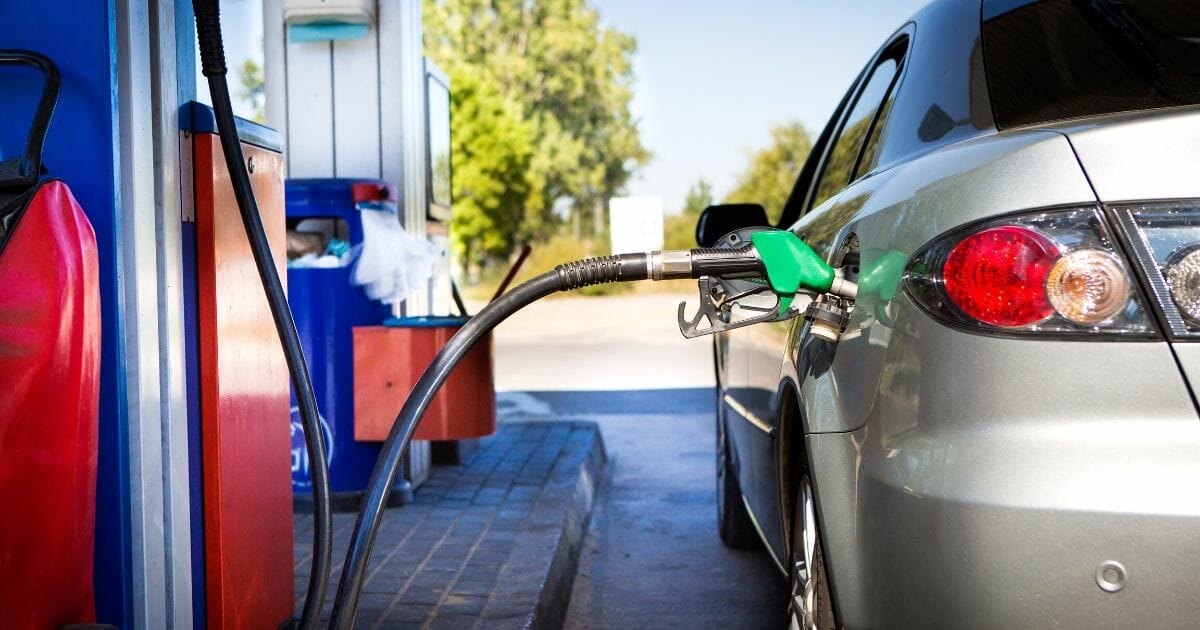 Stock image of a car refueling at a gas station.