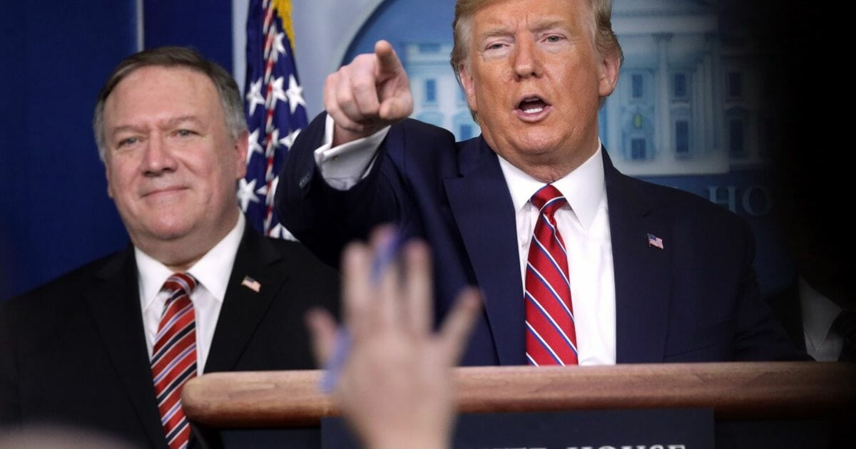 President Donald Trump takes questions as Secretary of State Mike Pompeo looks on during Friday's White House news briefing on the latest development of the coronavirus outbreak in the U.S.