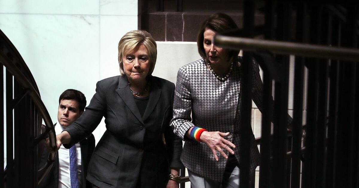 Accompanied by then-House Minority Leader Nancy Pelosi, right, then-Democratic presidential candidate Hillary Clinton leaves after meeting with House Democrats on June 22, 2016, in Washington, D.C.