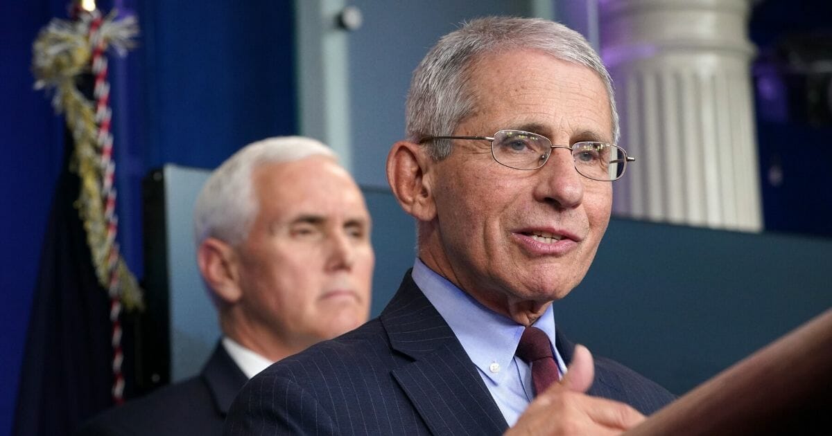 Dr. Anthony Fauci, director of the National Institute of Allergy and Infectious Diseases, speaks as Vice President Mike Pence listens during the daily White House coronavirus briefing on March 31, 2020.