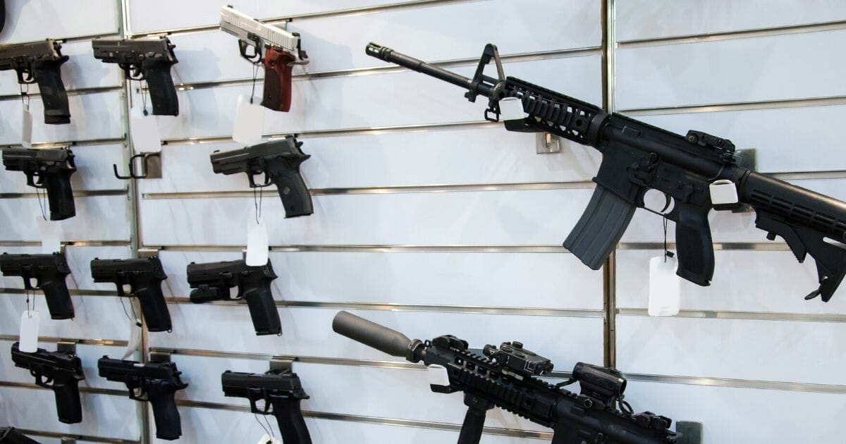 Stock image of firearms on display at a gun store.