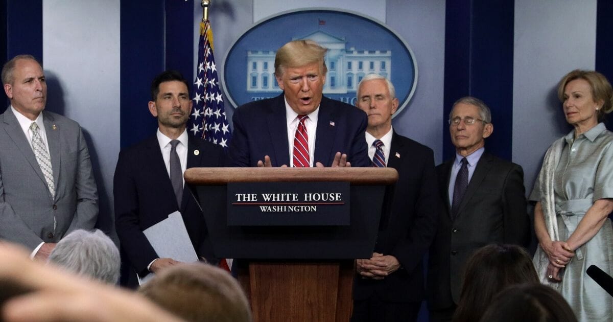 Flanked by members of the coronavirus task force, President Donald Trump speaks during a news briefing on the latest development of the coronavirus outbreak in the U.S. at the James Brady Press Briefing Room at the White House on March 20, 2020, in Washington, D.C.