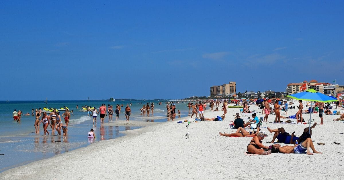 People gather on Clearwater Beach during spring break despite world health officials’ warnings to avoid large groups on March 18, 2020, in Clearwater, Florida.