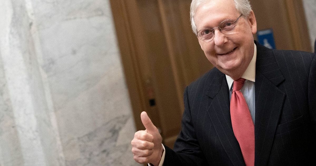 Senate Majority Leader Mitch McConnell gives a thumbs-up sign as he arrives at the Capitol on March 25, 2020.