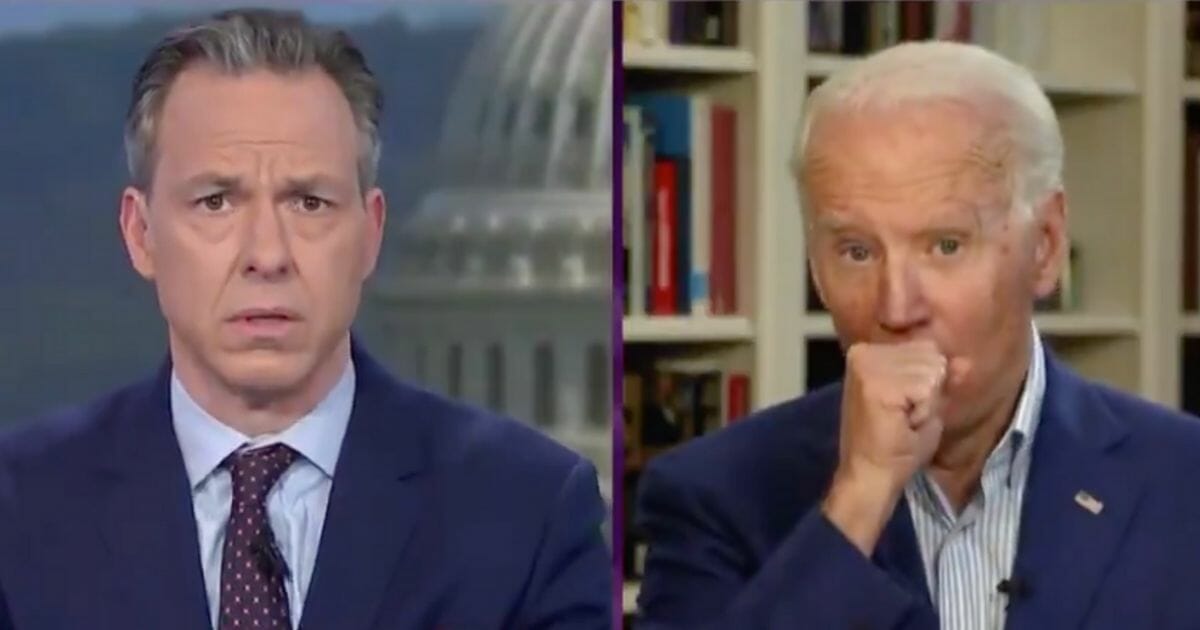 Former Vice President Joe Biden coughs into his hand, violating CDC guidelines, during an interview with CNN’s Jake Tapper.