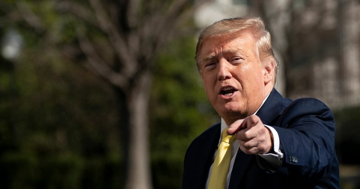 President Donald Trump gestures as he walks toward the White House residence after exiting Marine One on the South Lawn of the White House on March 9, 2020, in Washington, D.C.