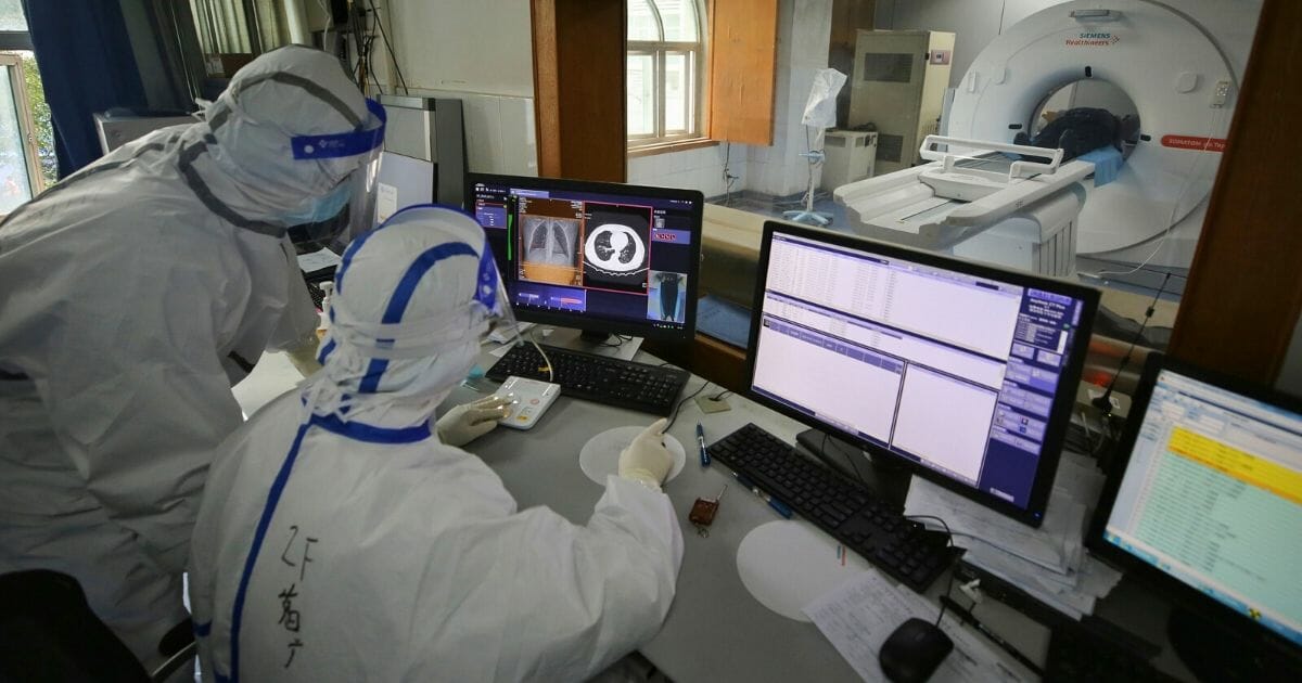 Medical staff conduct a CT scan for a patient infected by the COVID-19 coronavirus at Red Cross Hospital in Wuhan in China's central Hubei province on March 11, 2020.