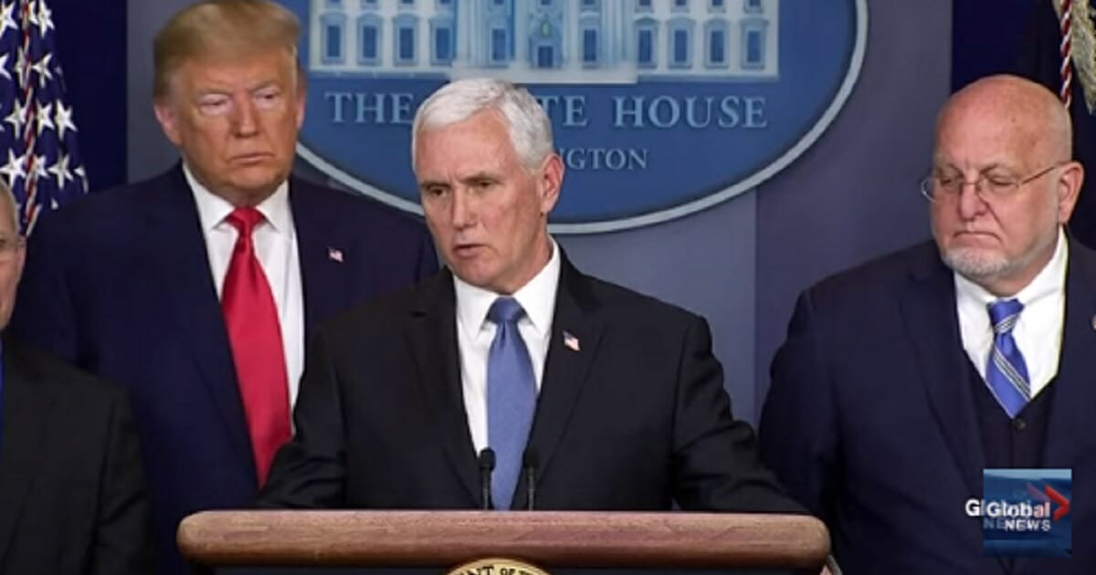 Vice President Mike Pence speaks at a news conference Saturday, accompanied by President Donald Trump, left.