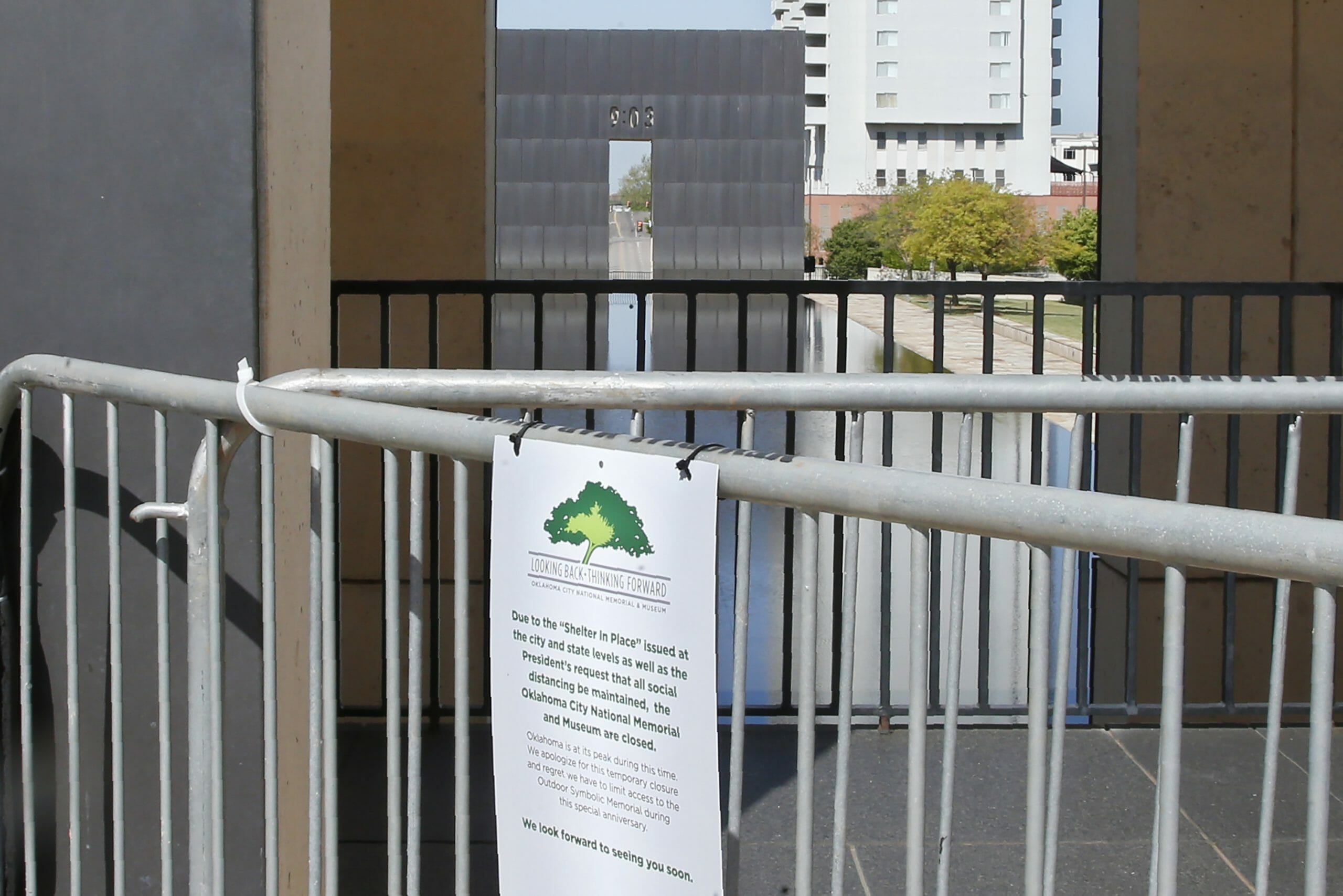 The 9:02 Gate at the Oklahoma City National Memorial and Museum is pictured behind a sign announcing the closure of the site, Wednesday in Oklahoma City.