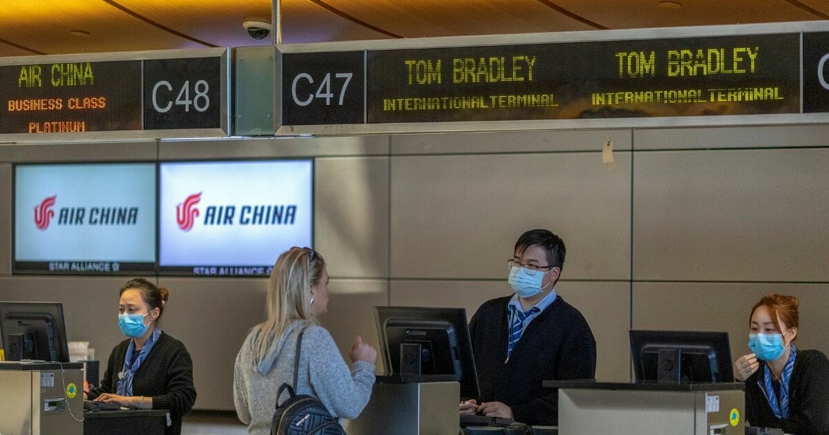 Air China employees wear medical masks for protection