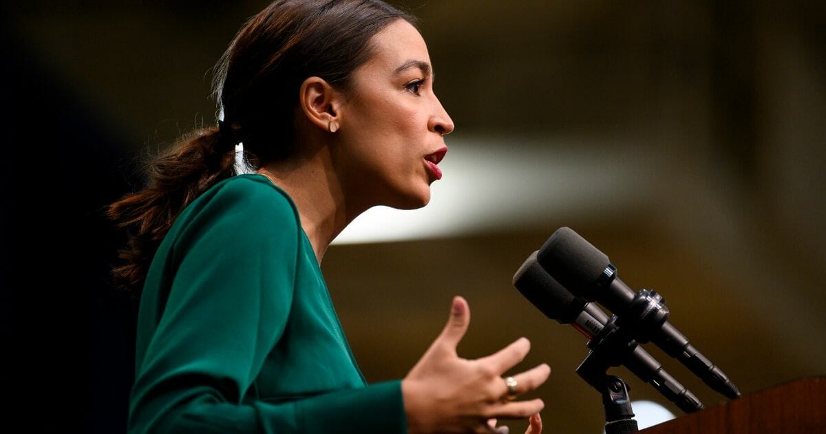 Rep. Alexandria Ocasio-Cortez (D-New York) takes the stage before speaking at the Climate Crisis Summit at Drake University on Nov. 9, 2019, in Des Moines, Iowa.