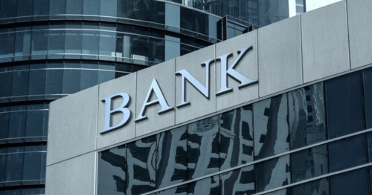 A stock photo of a bank is seen above.