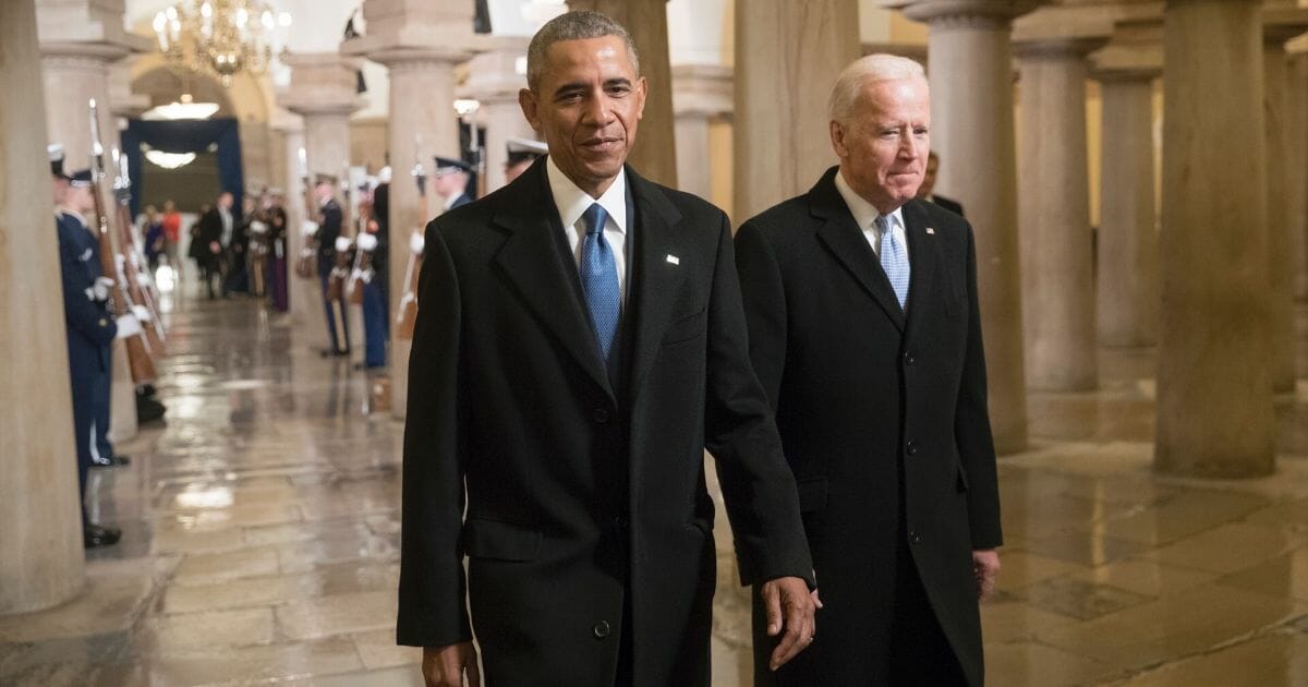 Then-President Barack Obama, left, and then-Vice President Joe Biden walk through the Crypt of the Capitol for Donald Trump's inauguration ceremony in Washington, D.C., on Jan. 20, 2017.