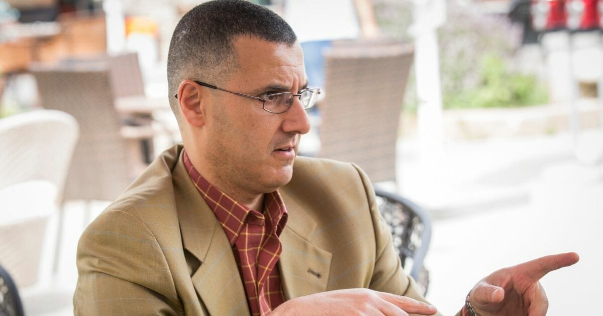 Omar Barghouti speaks to artists traveling with the Palestine Festival of Literature about the anti-Israel boycott, divestment and sanctions campaign June 3, 2014, in Acre, Israel.