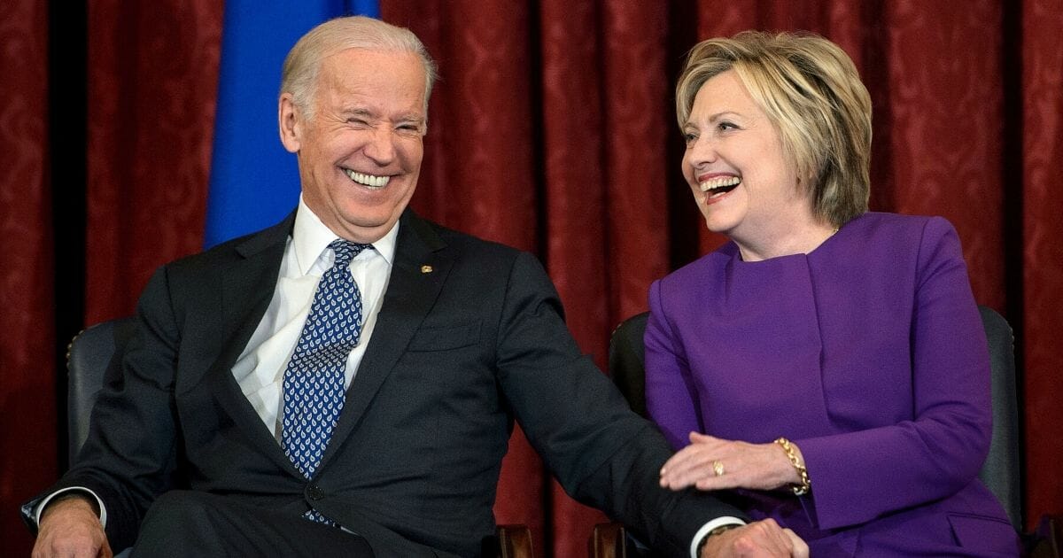 Former Vice President Joe Biden and former Secretary of State Hillary Clinton laugh during a portrait unveiling for outgoing Senate Minority Leader Senator Harry Reid on Capitol Hill in Washington on Dec. 8, 2016.