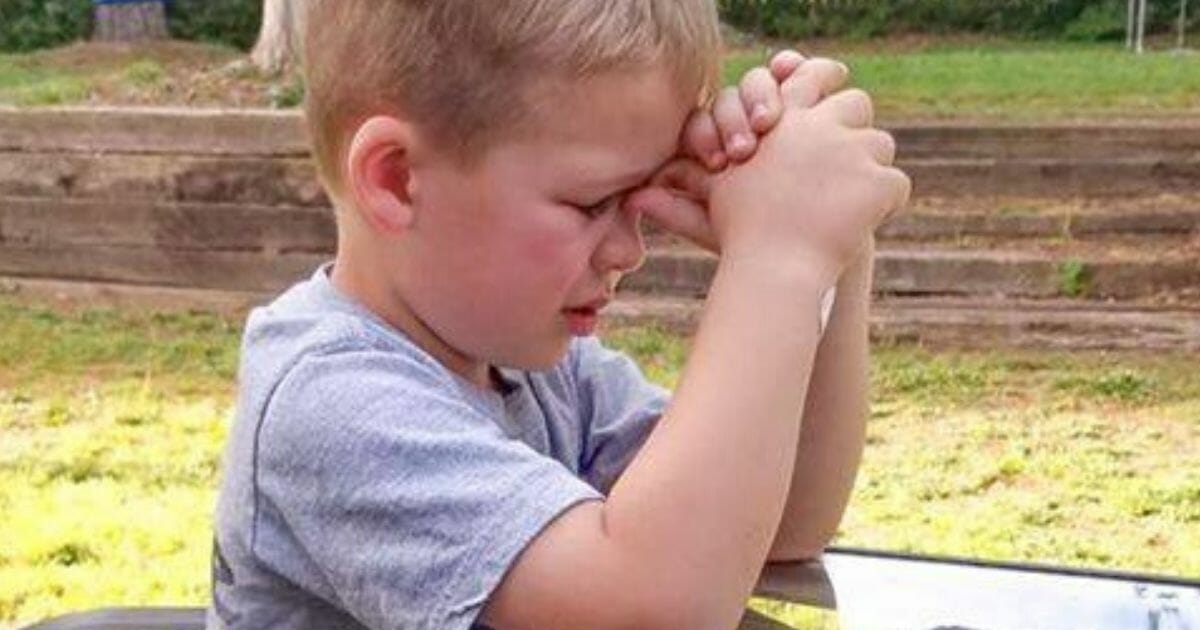 One mom caught this heartwarming picture of her son praying for his grandpa, who is in the hospital