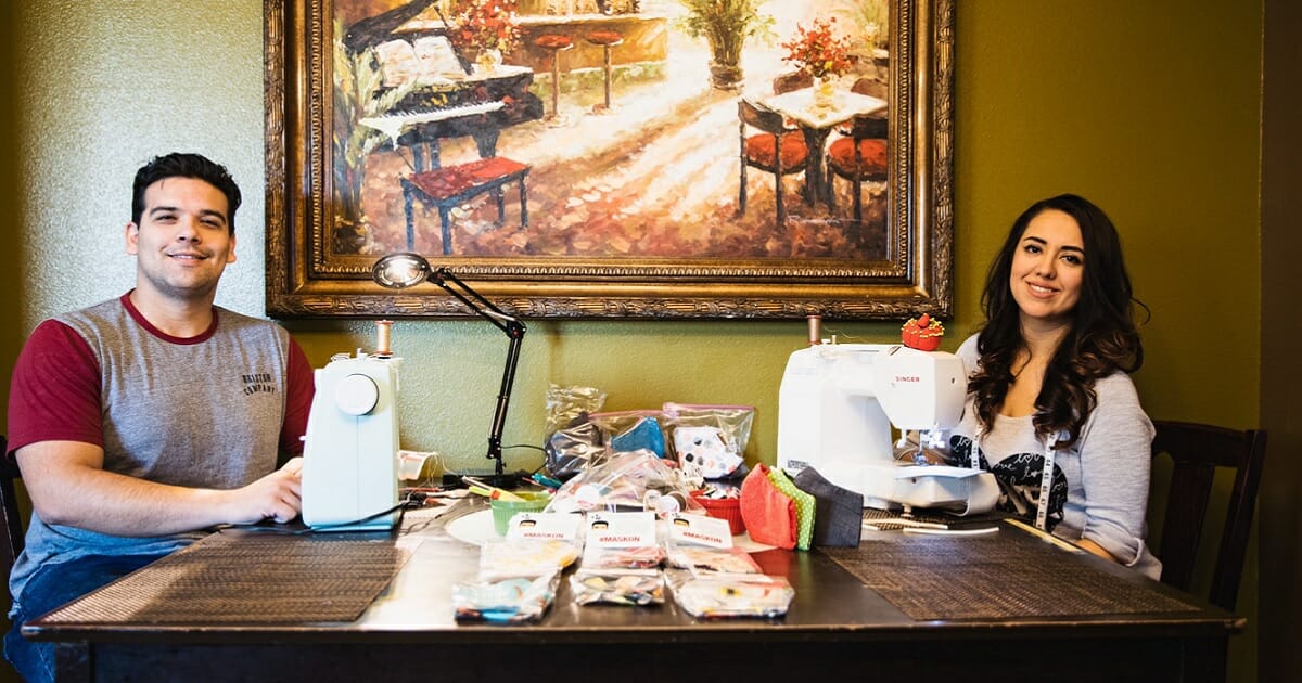 Customs and Border Protection Agent Ricardo Ruedas and his wife, Alejandra, sit at a table with small sewing machines.