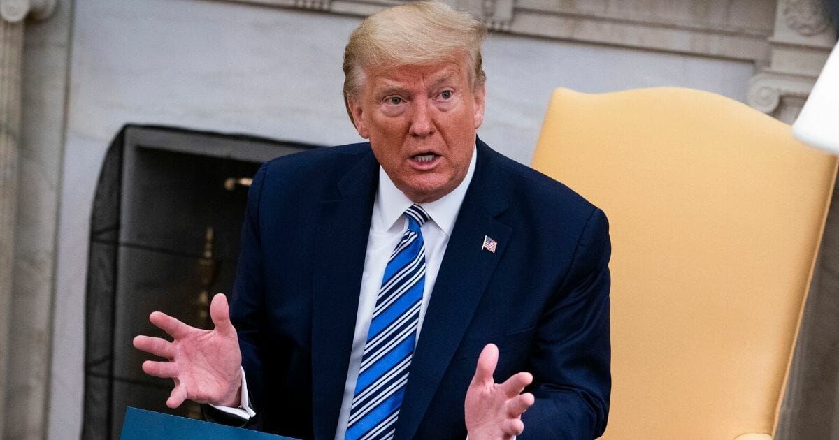 President Donald Trump answers questions in the Oval Office of the White House on April 28, 2020, in Washington, D.C.