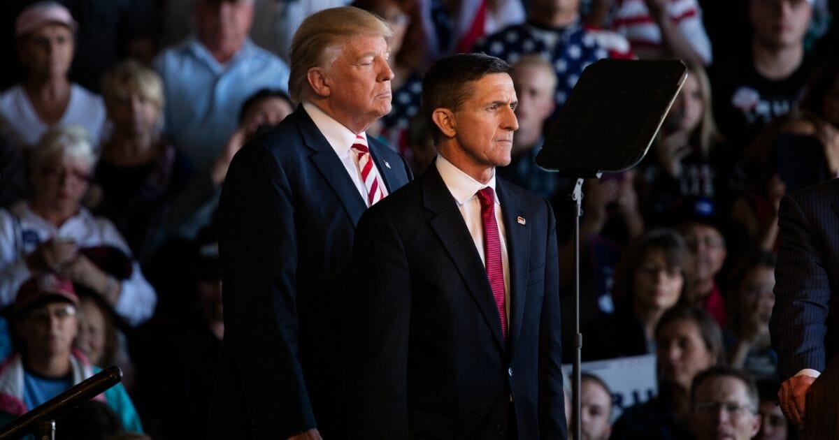 Then-Republican presidential nominee Donald Trump and retired Lieutenant General Mike Flynn are seen at a rally inside an aircraft hangar in Grand Junction, Colorado, on Oct. 18, 2016.