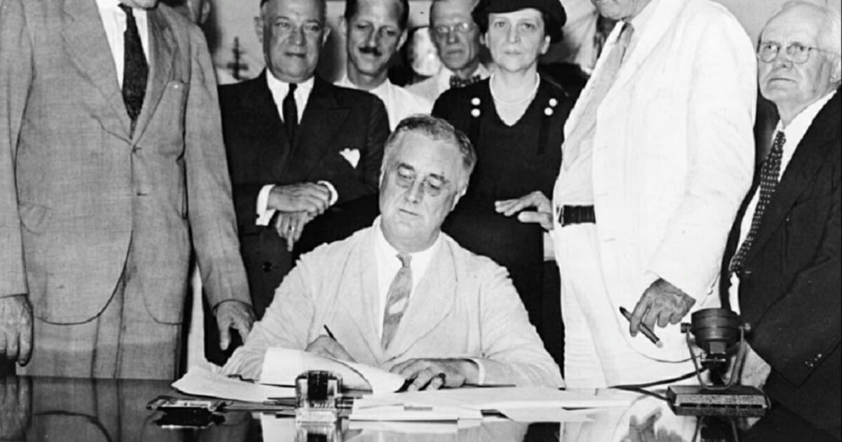 President Franklin Delano Roosevelt signs the Social Security Act in 1937.