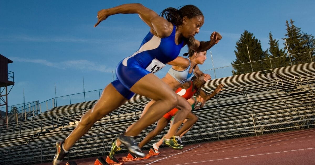 Female athletes are seen racing against each other in the stock photo above.