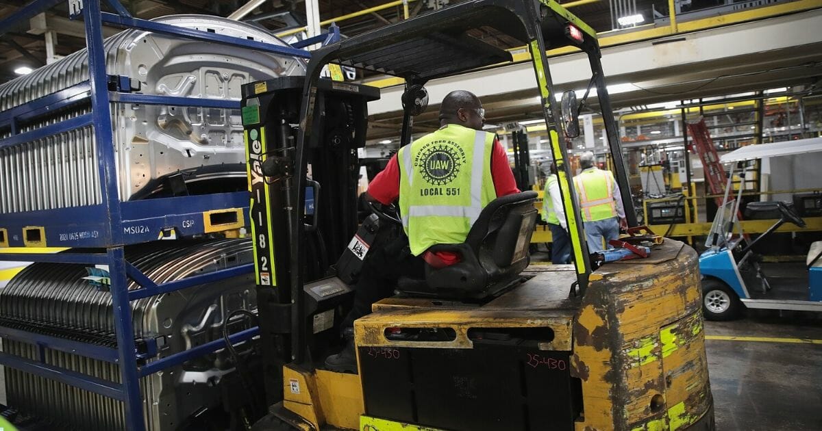 Workers assemble Ford vehicles at the Chicago Assembly Plant on June 24, 2019, in Chicago, Illinois.