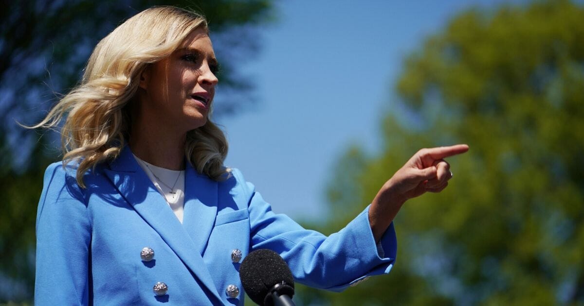 White House press secretary Kayleigh McEnany speaks to reporters on the driveway in front of the White House in Washington on April 22, 2020.