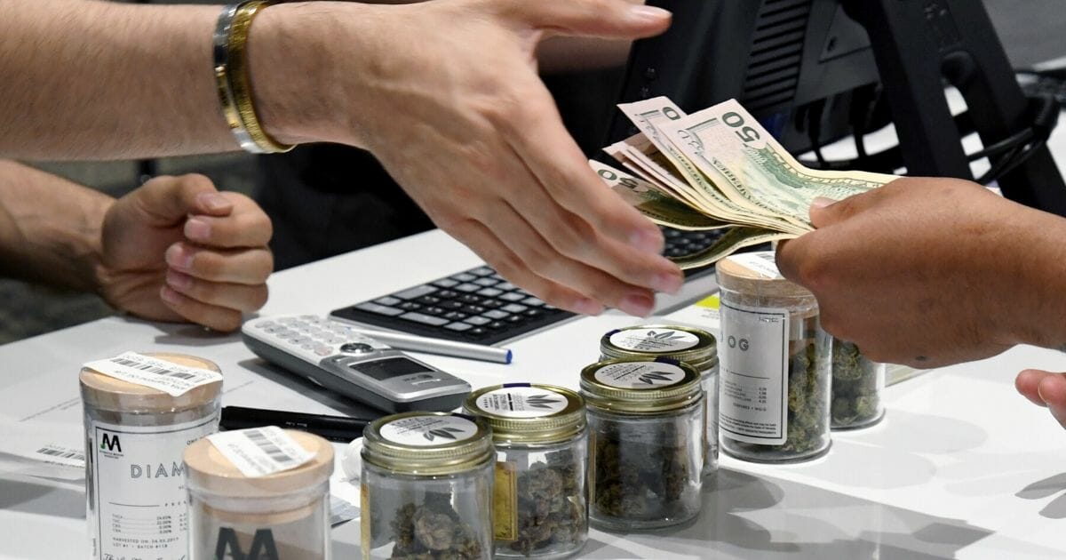 A customer pays for cannabis products at Essence Vegas Cannabis Dispensary after the start of recreational marijuana sales began on July 1, 2017, in Las Vegas, Nevada.