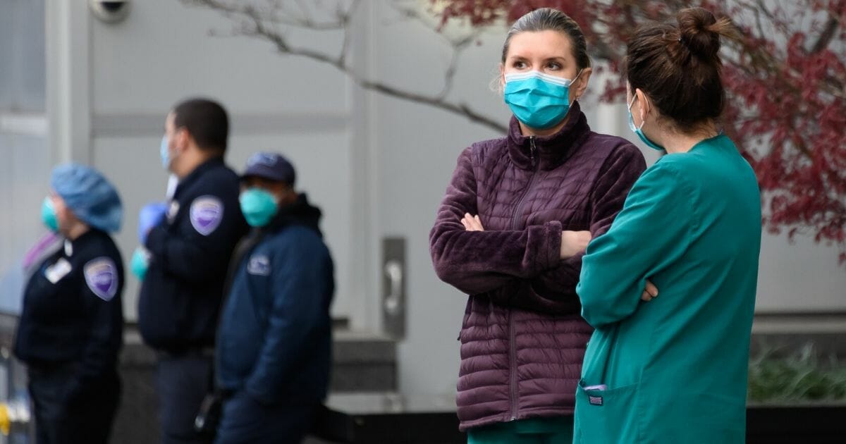 Medical personnel wear protective masks outside NYU Langone Health hospital in New York City on April 4, 2020.