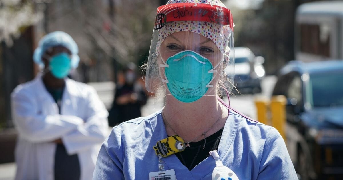 A member of the medical staff listens as Montefiore Medical Center nurses call for N95 masks and other critical PPE to handle the coronavirus pandemic on April 1, 2020, in New York.