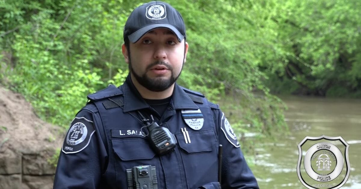 Officer Luis Salas managed to rescue two teens trapped in a river.