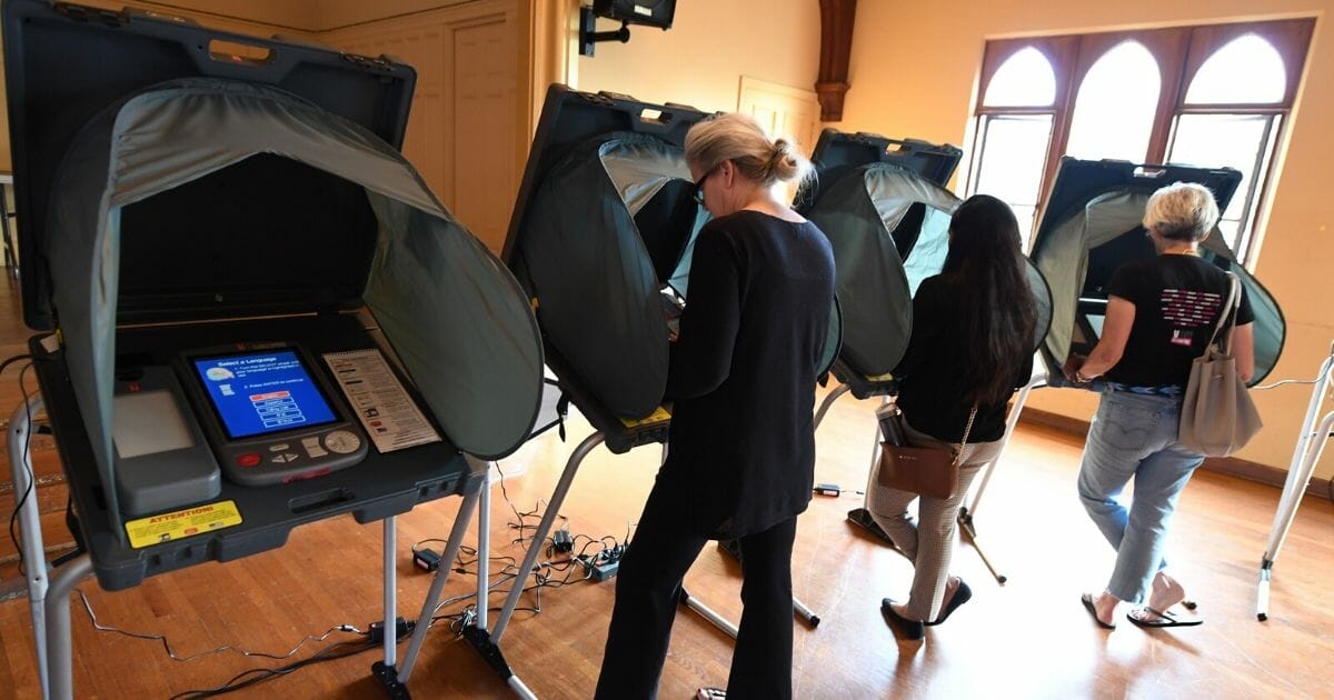 People use electronic voting machines to cast their ballot in the midterm elections at Neighborhood Congregational Church in Laguna Beach, California, on Nov. 6, 2018.