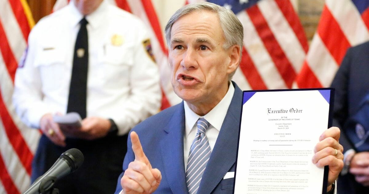 Texas Gov. Greg Abbott holds a new executive order related to the coronavirus during a news conference at the state Capitol in Austin on March 29, 2020.