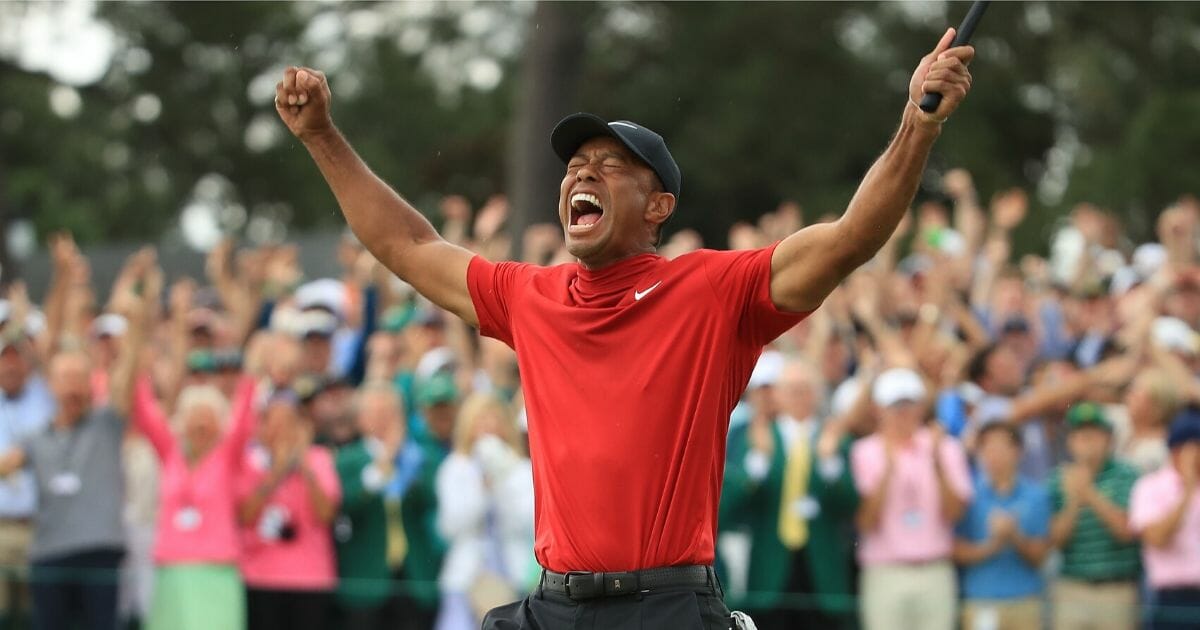 Tiger Woods celebrates on the 18th green after winning the Masters at Augusta National Golf Club in Georgia on April 14, 2019.