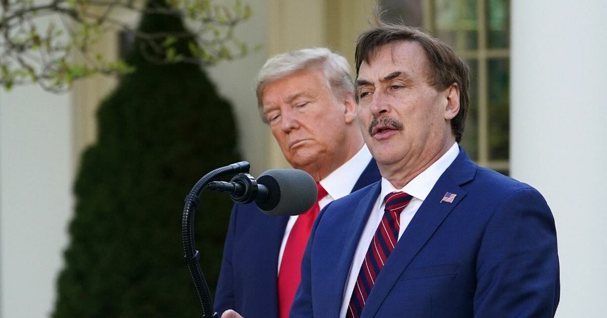 President Donald Trump listens as Michael J. Lindell, CEO of MyPillow Inc., speaks during the daily briefing on the novel coronavirus in the Rose Garden of the White House in Washington, D.C, on March 30, 2020.
