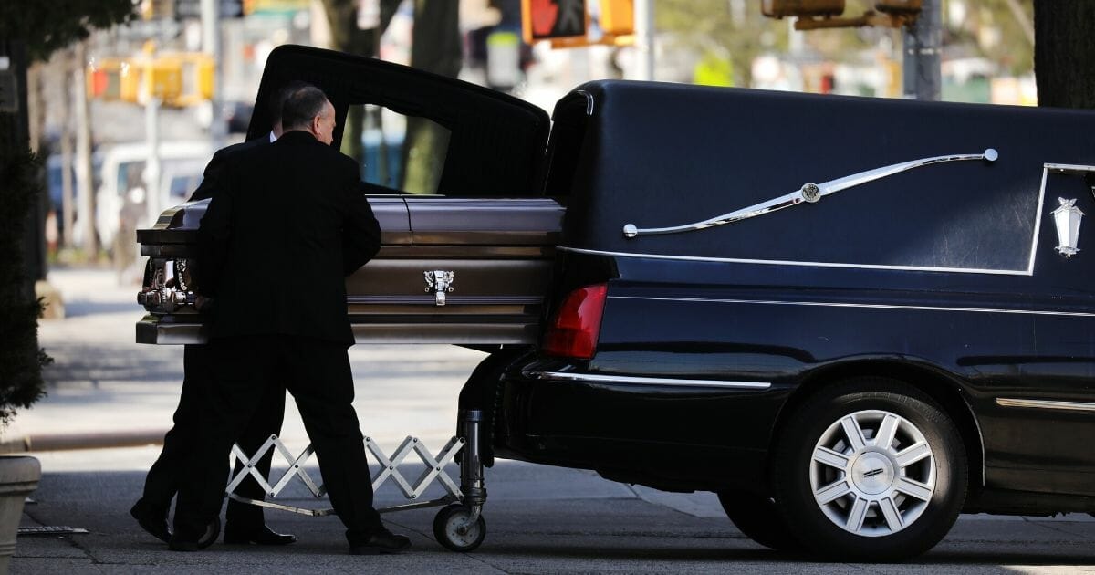 A casket is placed into a hearse outside of a funeral home in the heavily Orthodox Borough Park neighborhood of Brooklyn on April 16, 2020, in New York City.