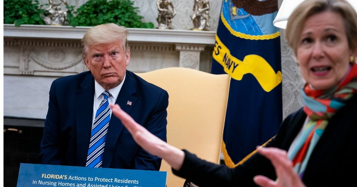 White House Coronavirus Task Force Coordinator Dr. Deborah Birx, right, answers a question while meeting with President Donald Trump and Florida Gov. Ron DeSantis in the Oval Office of the White House on April 28, 2020, in Washington, D.C.