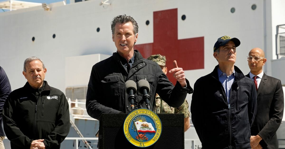 California Gov. Gavin Newsom speaks in front of the hospital ship USNS Mercy that arrived at the Port of Los Angeles on March 27, 2020, to provide relief for Southland hospitals overwhelmed by the coronavirus pandemic.