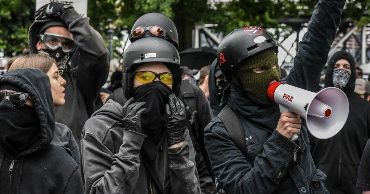Antifa protestors hide their faces at a protest on August 17, 2019, in Portland, Oregon